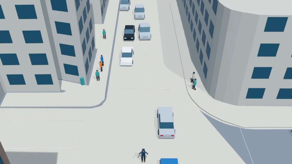 Officer holds vehicles and admits the first pedestrian pair from the south sidewalk.